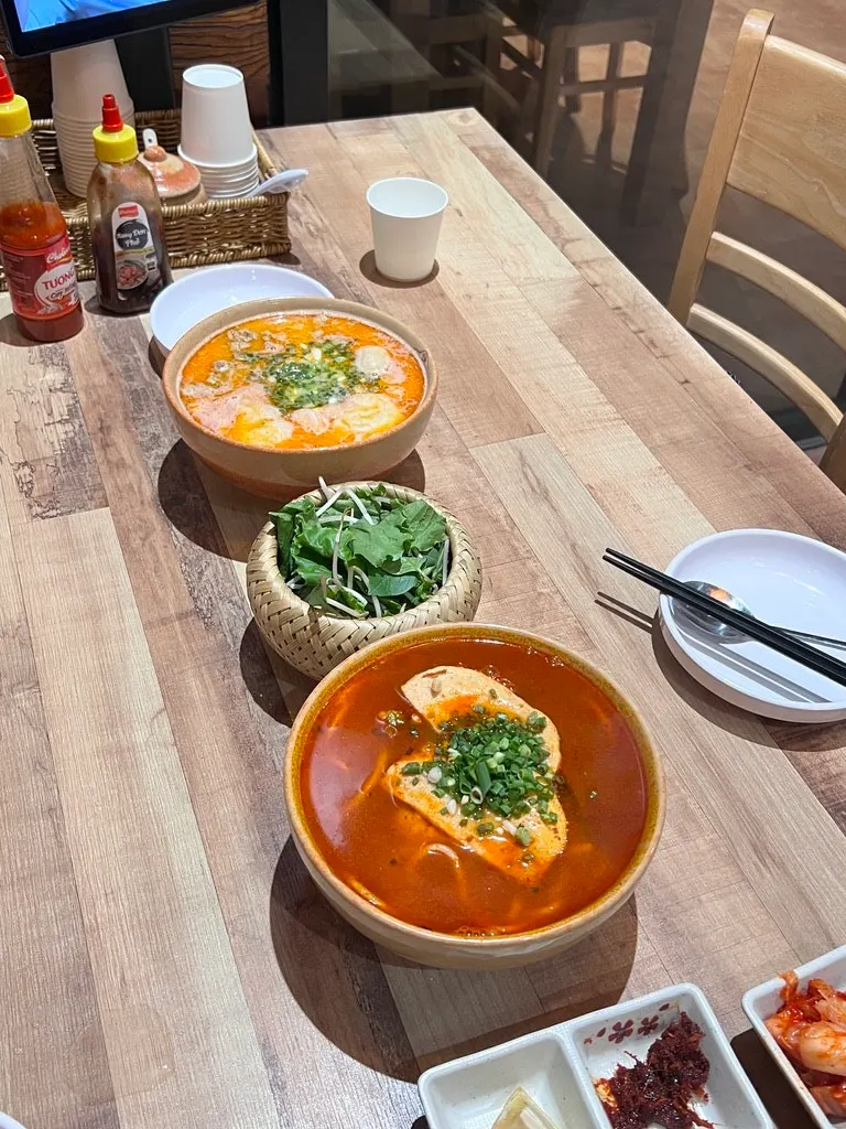 Bun bo Hue and tom yum pho set on the table at Madam Hao