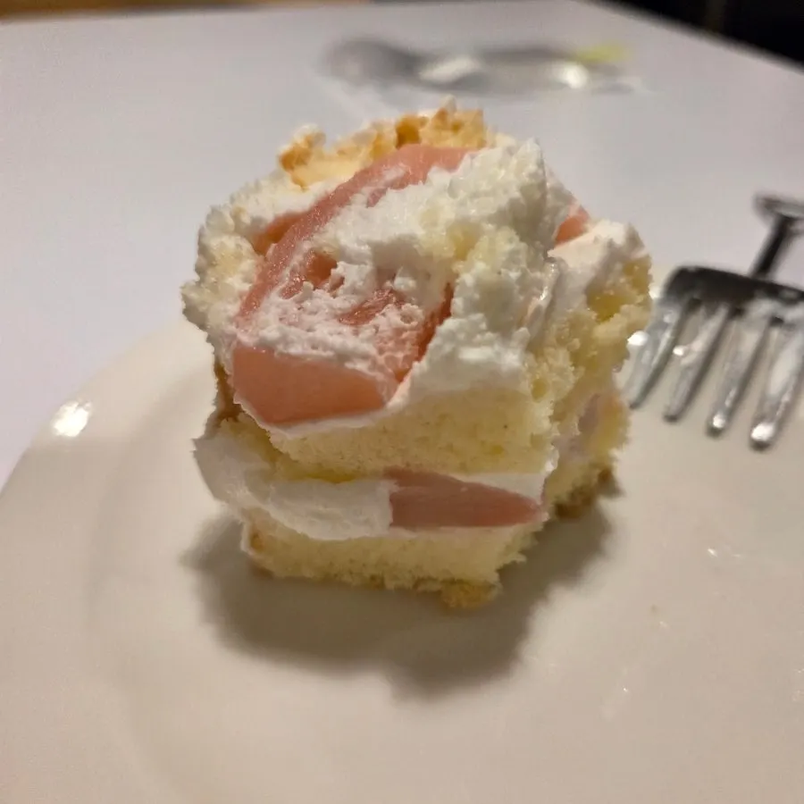 Peach topping visible on the yogurt cake
