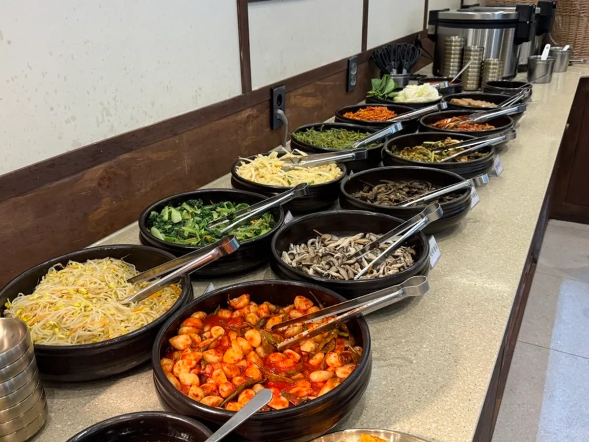 Neatly arranged namul and side dishes at the self-serve bar