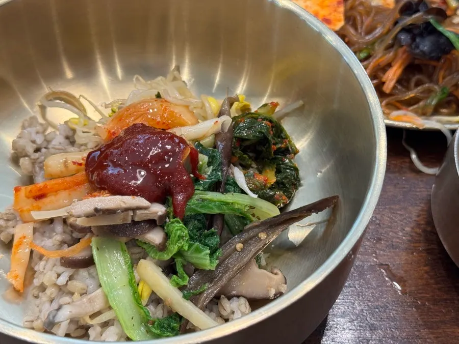 Preparing barley bibimbap with added yeolmu kimchi
