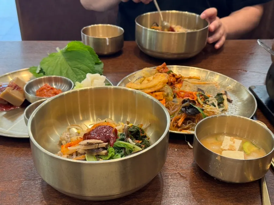 A full spread of barley bibimbap with cheonggukjang