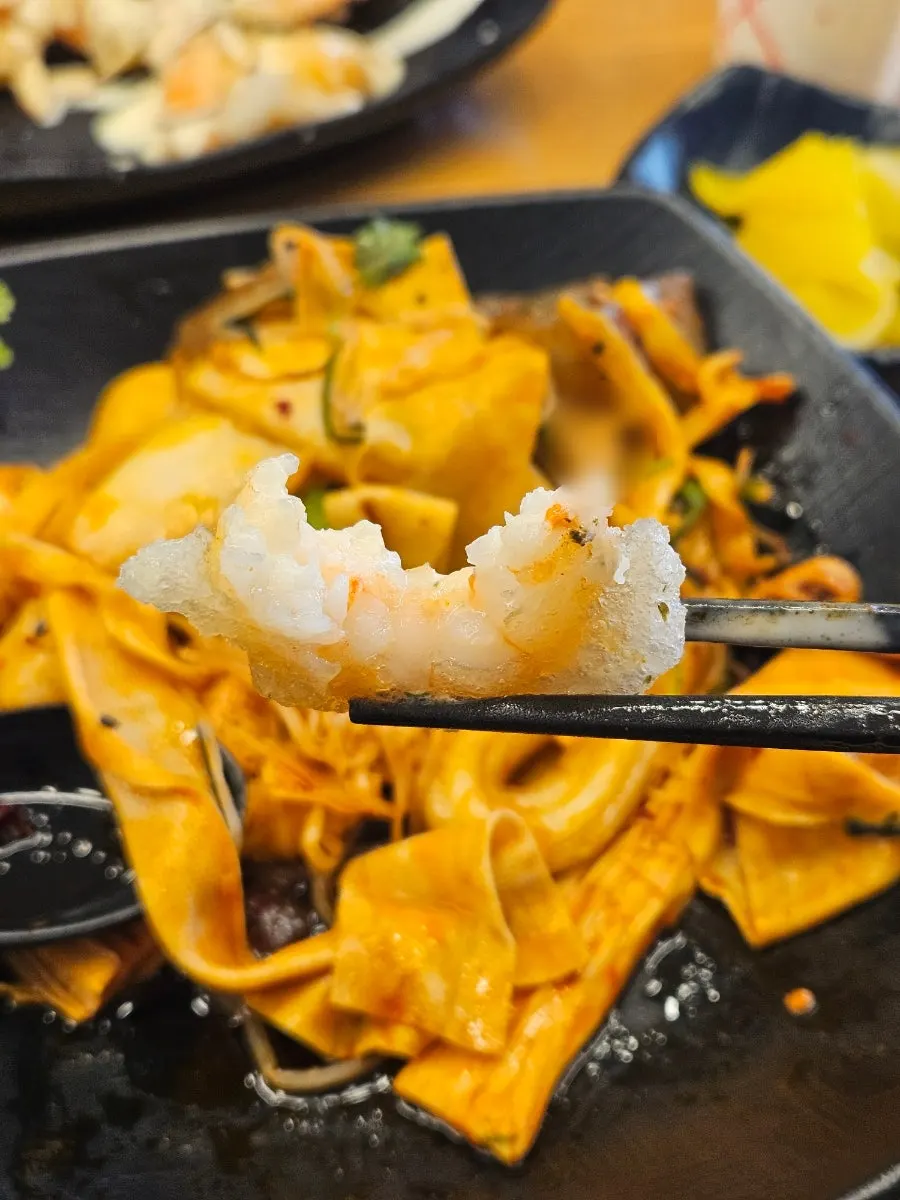 Table set with mala xiang guo and lemon cream shrimp together