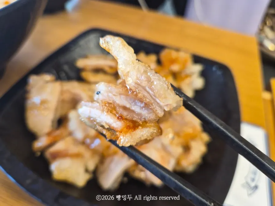 A piece of guabaorou coated in thick sauce