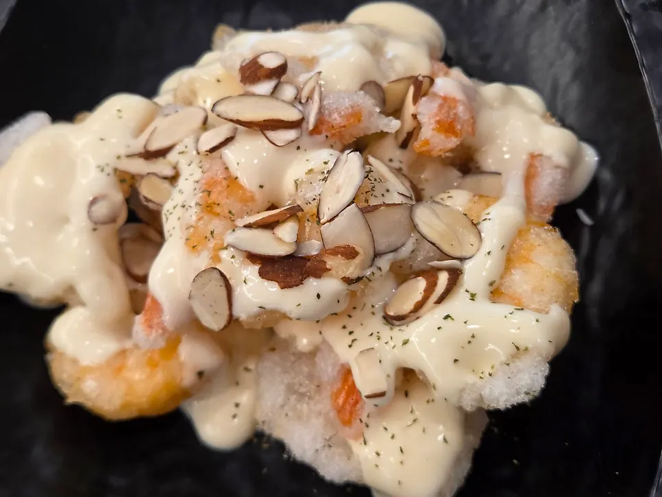 Lemon cream shrimp topped with cream sauce and sliced almonds