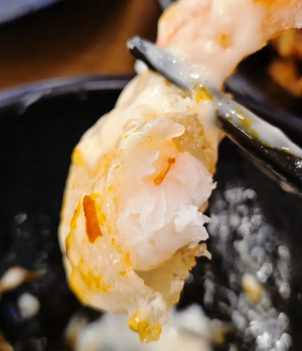 Picking up a piece of lemon cream shrimp