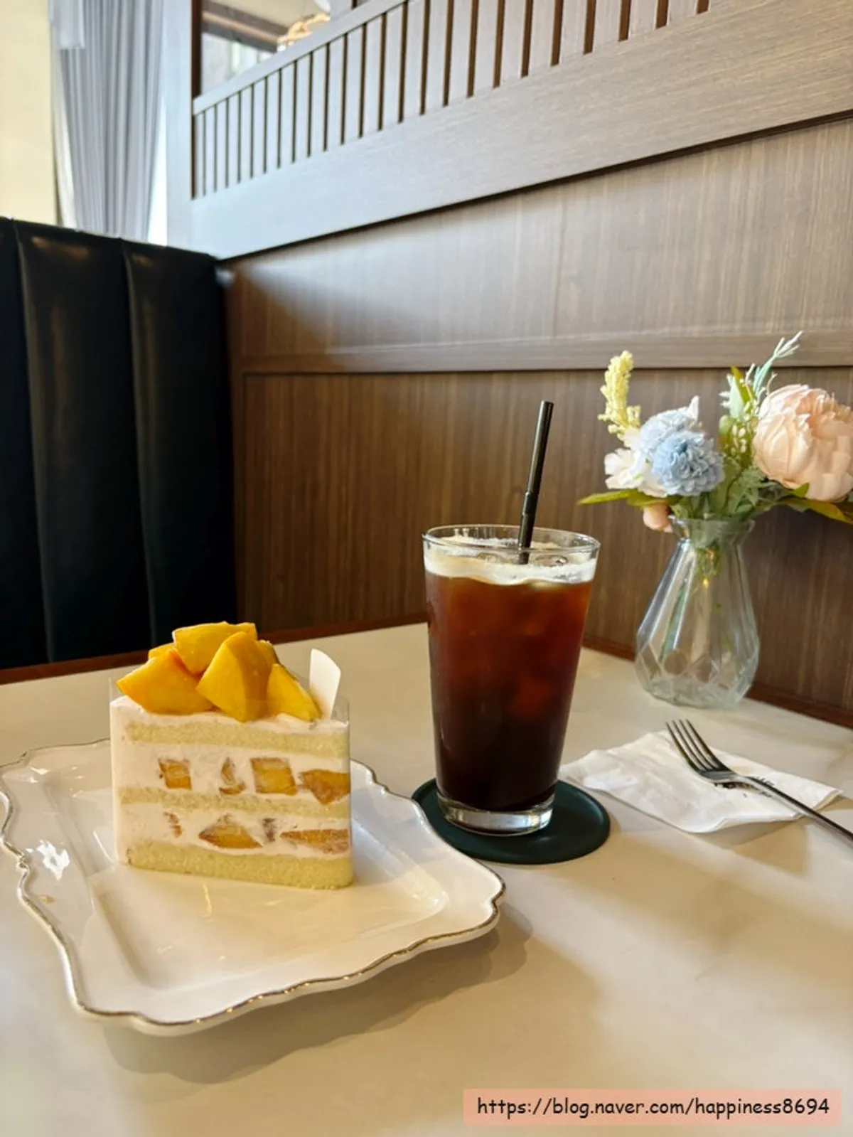 Slice cake topped with cream and fruit