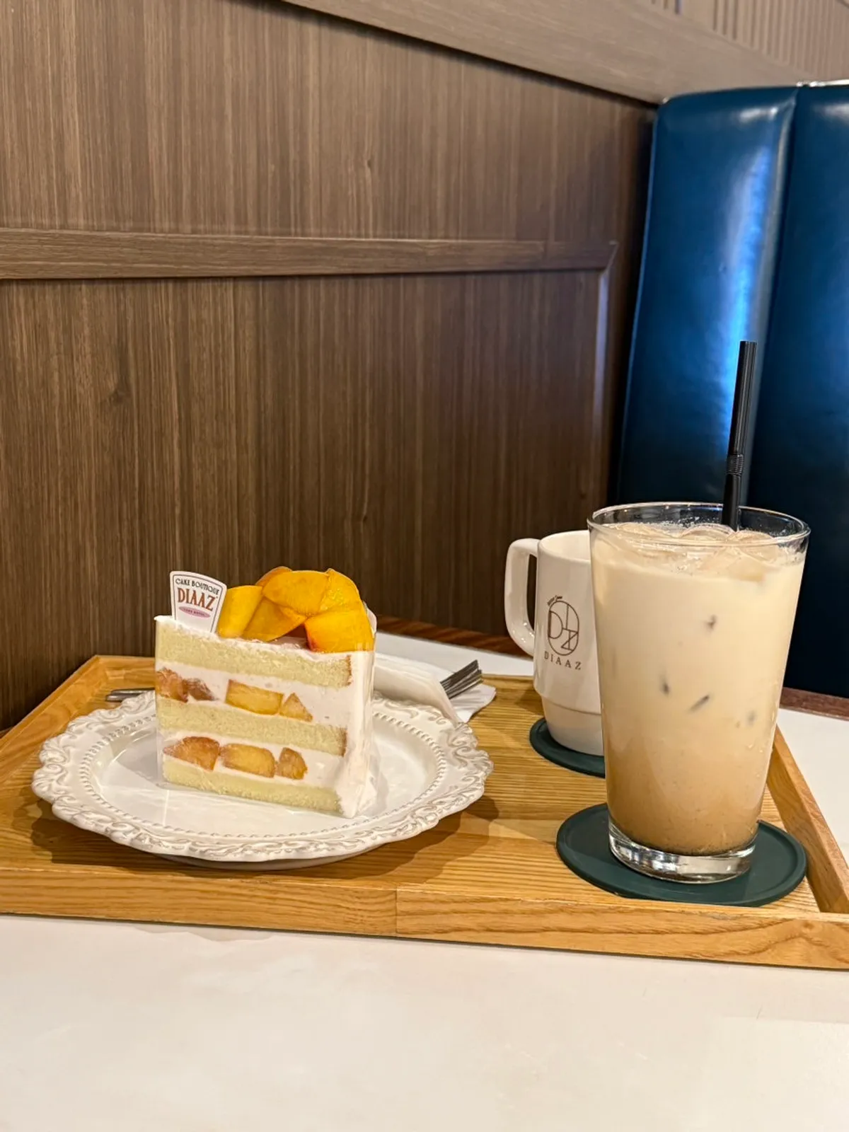 Table with peach cake, americano, and vanilla latte