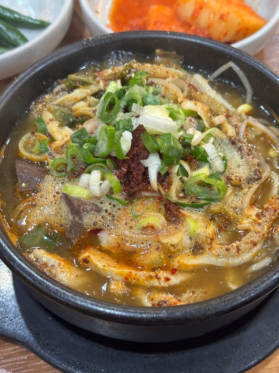 Steaming stone bowl of tripe soup