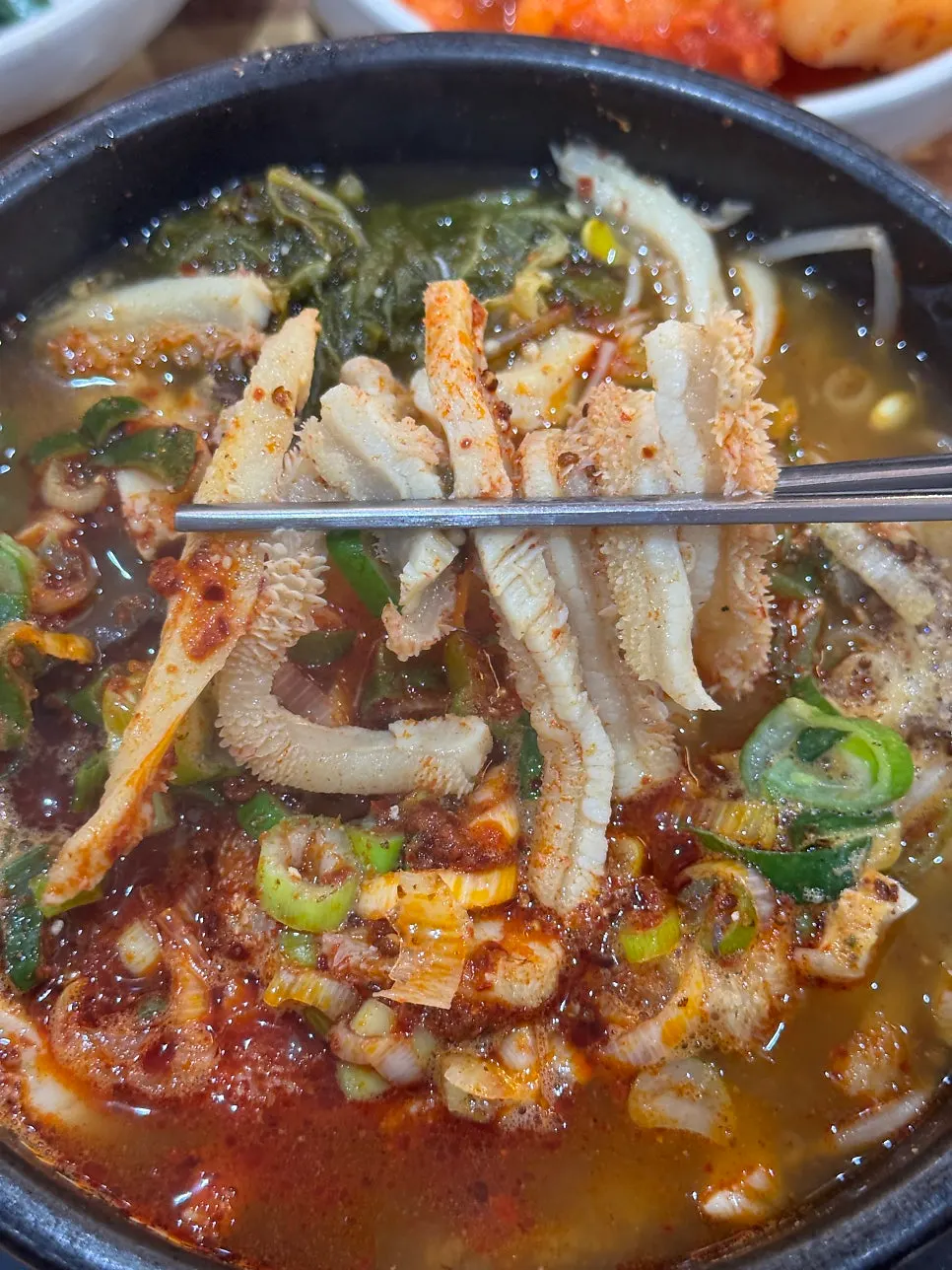 Tripe piece lifted with chopsticks