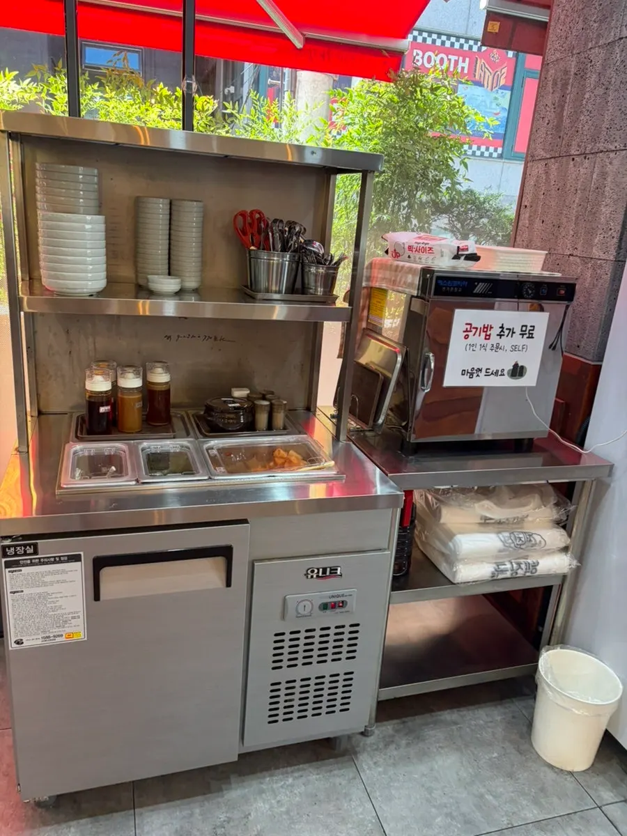 Utensils and sauces at the self-service corner