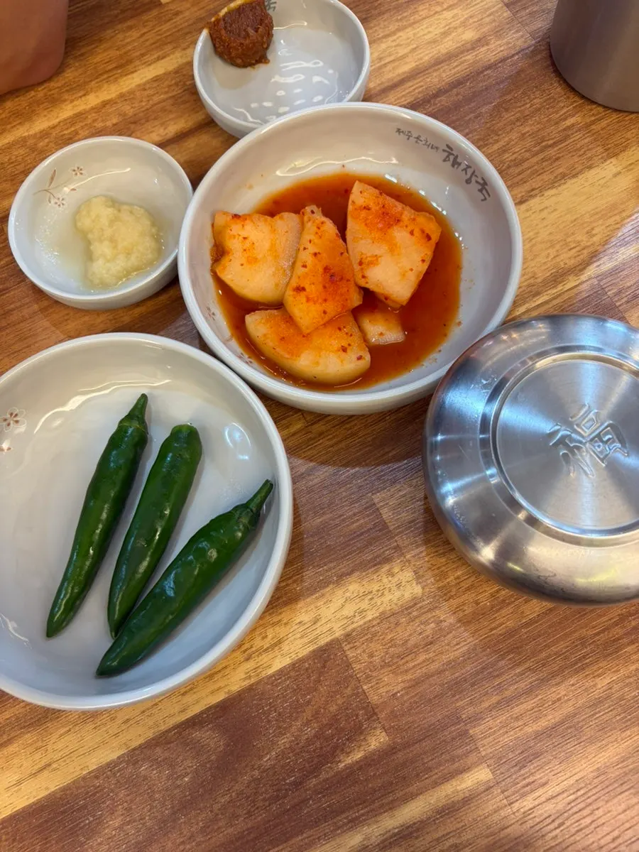 Diced radish kimchi, green chili peppers, and ssamjang side dishes
