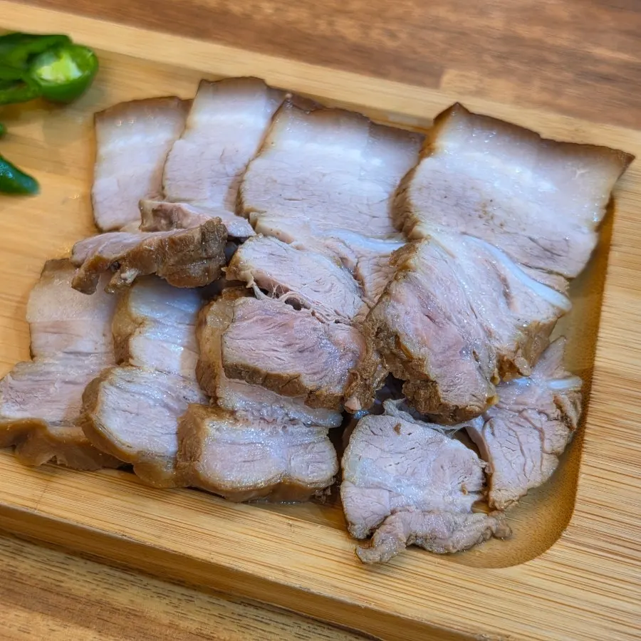 A piece of dombe pork dipped in sauce