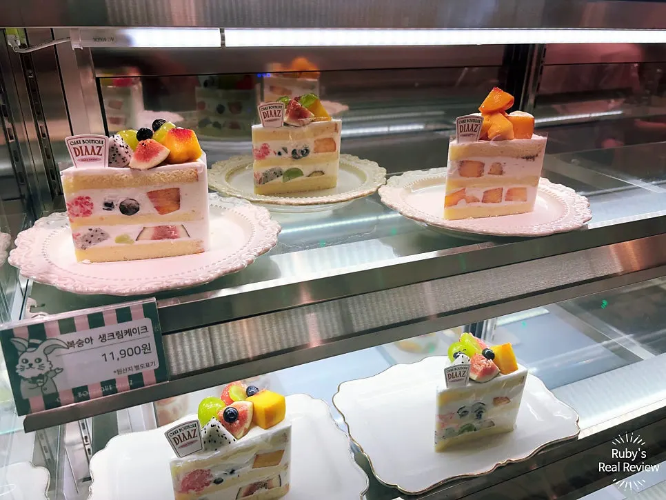 Fruit-topped cream cake glistening under the lights