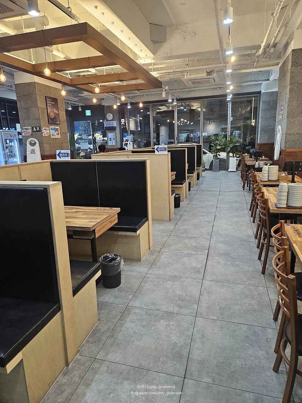 Spacious restaurant interior with tall-partition central sofa seating