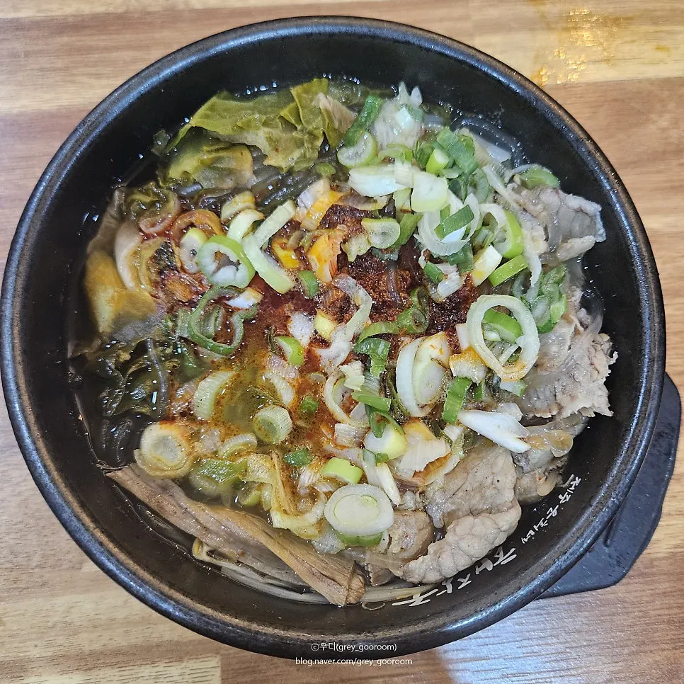 Close-up of haejangguk topped with chili paste and green onion