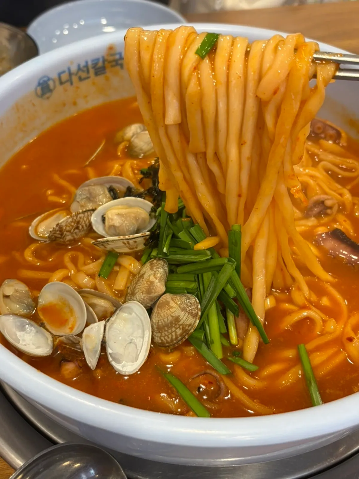 A bowl combining kalguksu noodles and octopus
