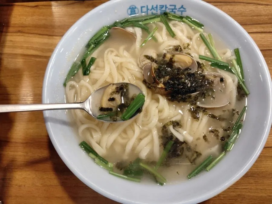 Kalguksu broth topped generously with seaweed flakes