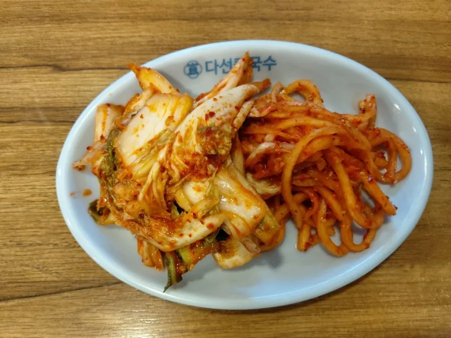 Chewy kalguksu noodles lifted with chopsticks