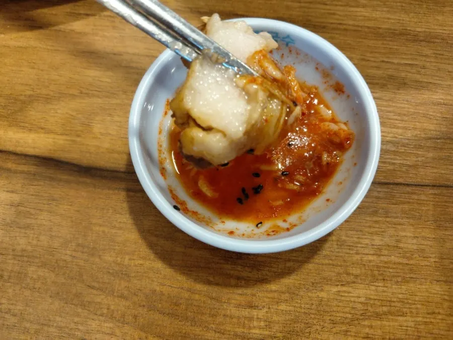 A piece of pork placed on top of kalguksu noodles