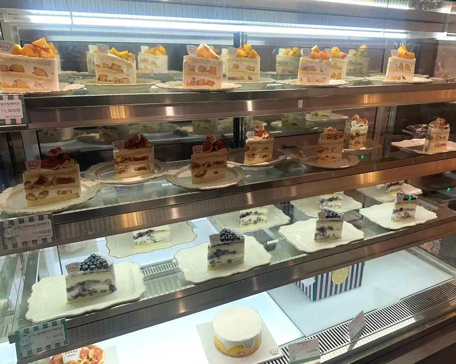 Showcase with peach, fig, and blueberry cake slices