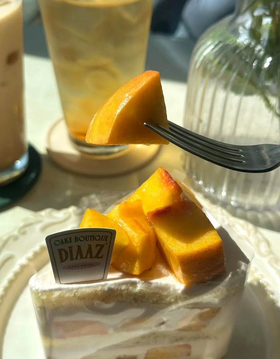 A slice of peach cake made with dairy fresh cream