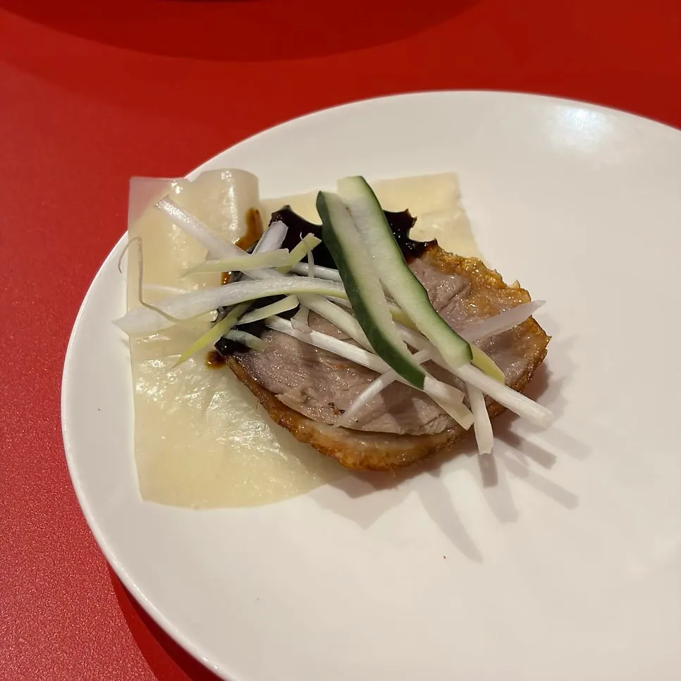 A plate of Peking duck wrapped in thin pancakes