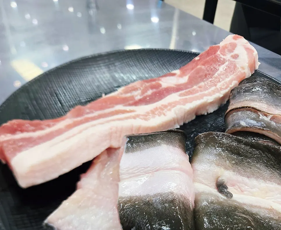 Pork belly and chicken neck meat on the grill