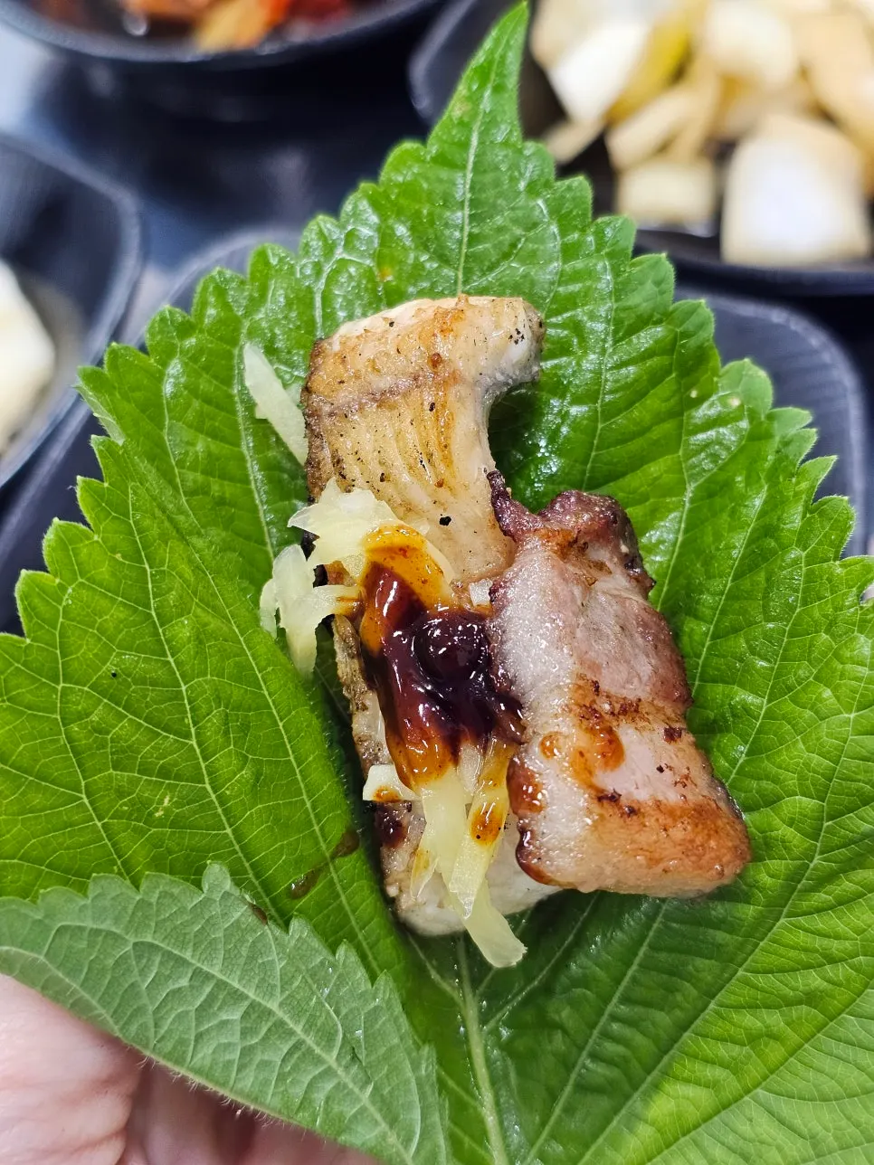 Eel samhap wrap topped with ginger