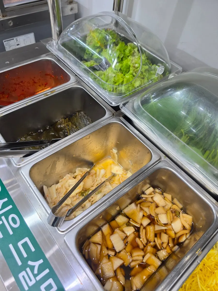 Sauces and side dishes displayed at the self-serve bar