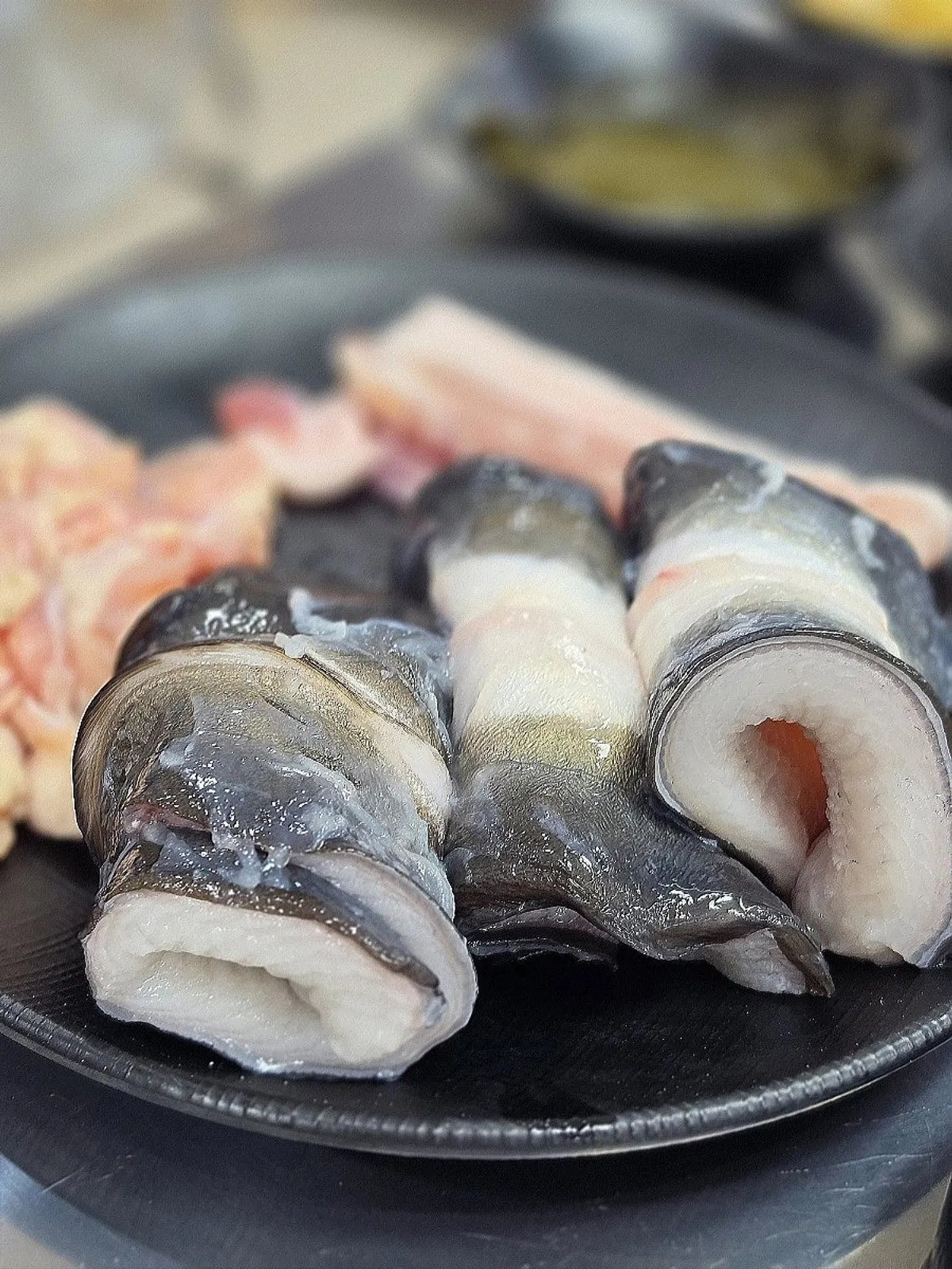 A plate with eel, pork belly and chicken neck meat together