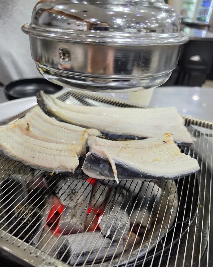 Whole freshwater eel placed on the charcoal grill