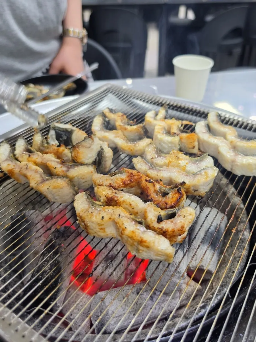 A piece of eel served with pickled sides