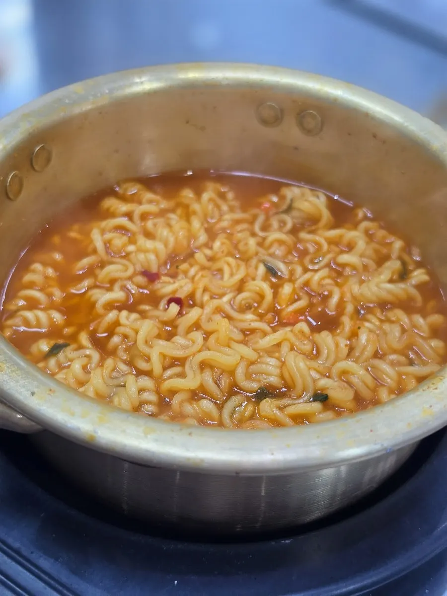 A bubbling pot of spicy ramyeon