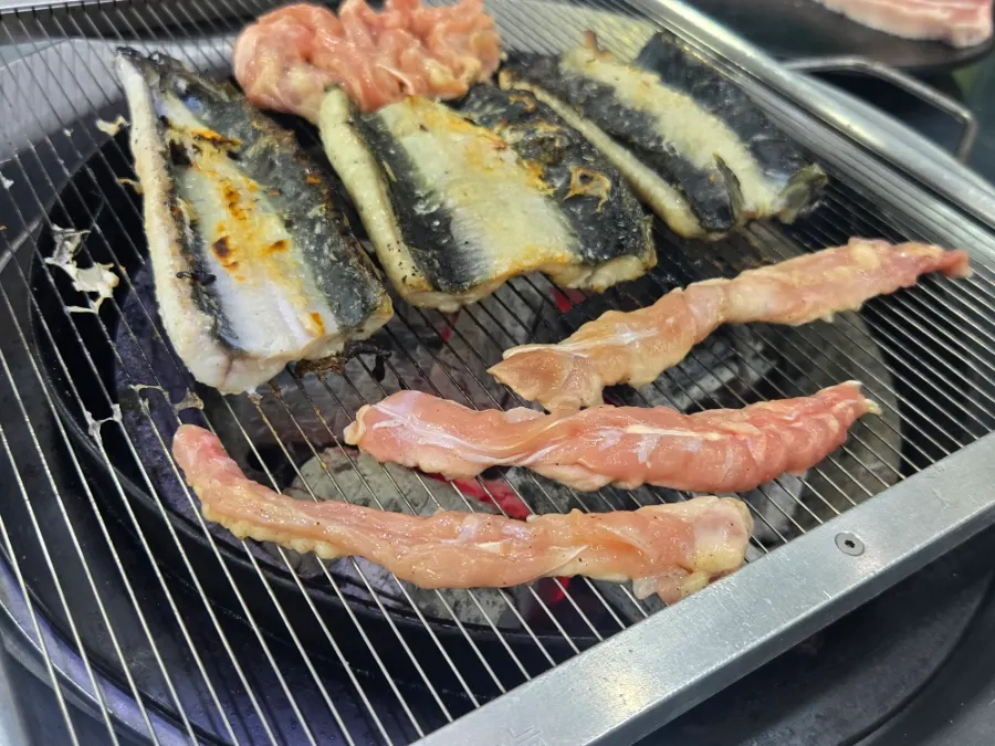 Pork belly and chicken neck meat on the charcoal grill