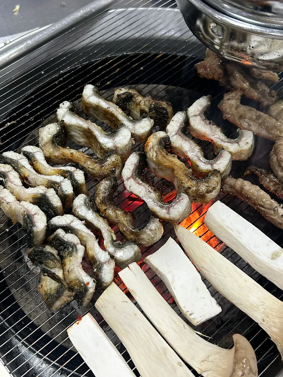 A piece of eel eaten with lettuce wrap vegetables