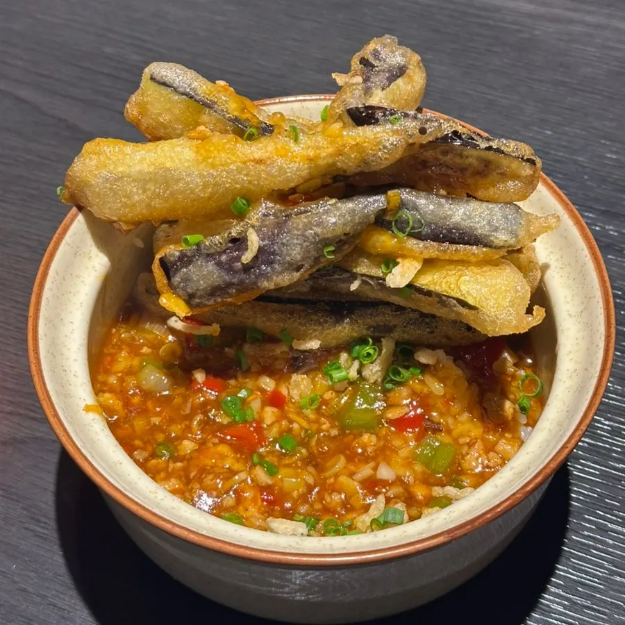 Chili sauce and white rice beneath the eggplant