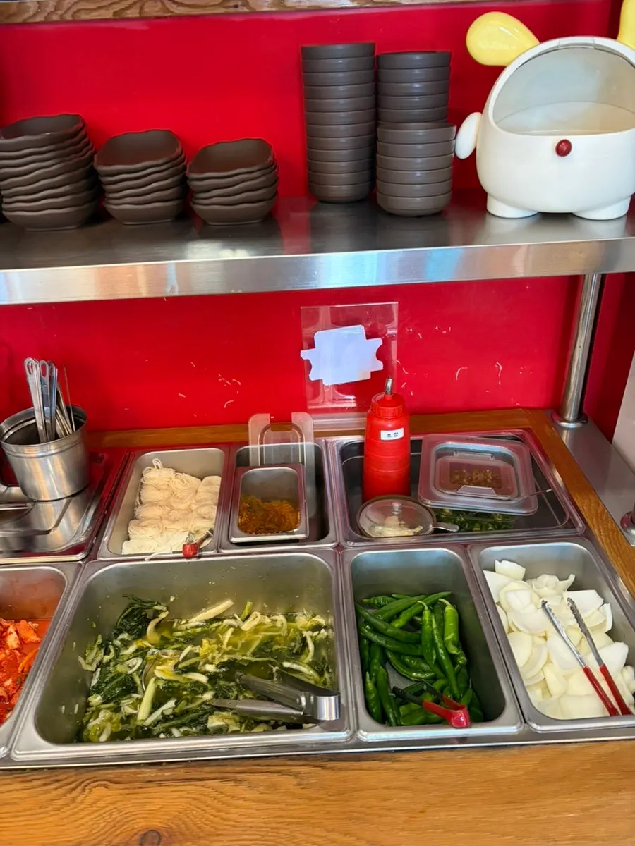 Self-service bar with side dishes and somyeon noodles