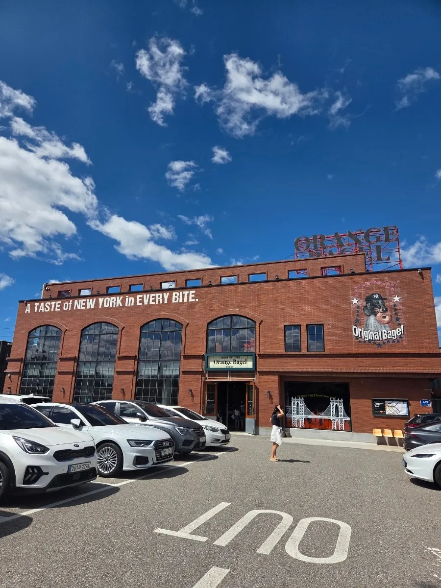 Orange Bagel's red-brick exterior under a blue sky