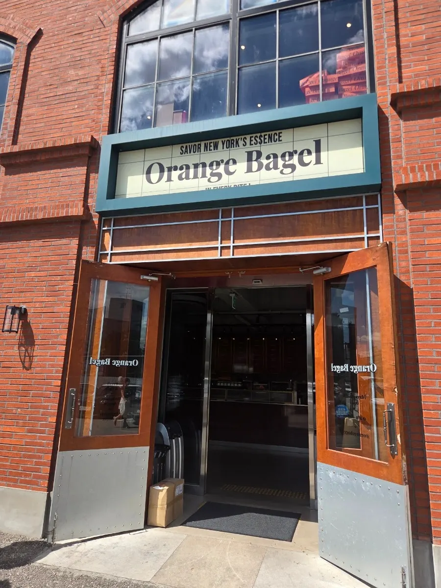 Orange Bagel sign and entrance with New York-style graphics