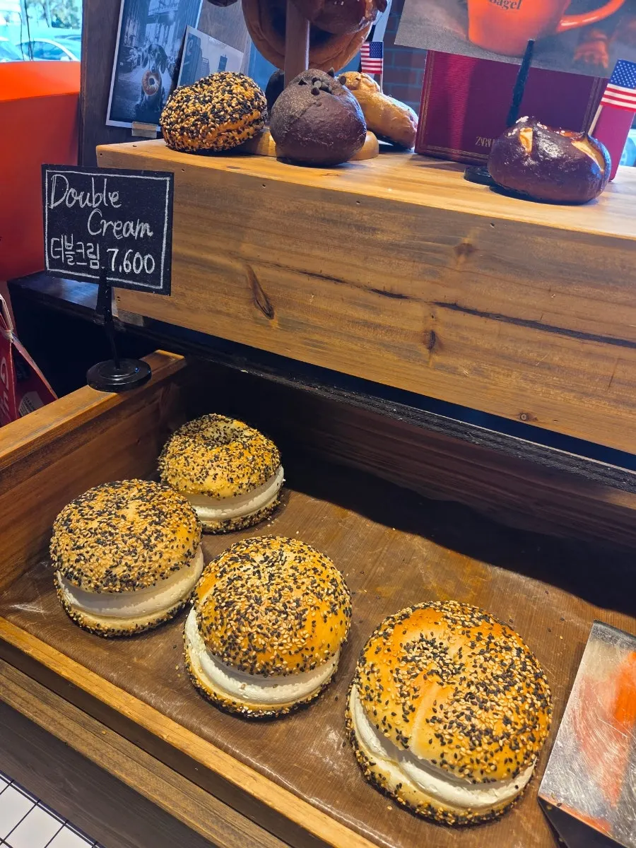 The three bagels on the table with coffee