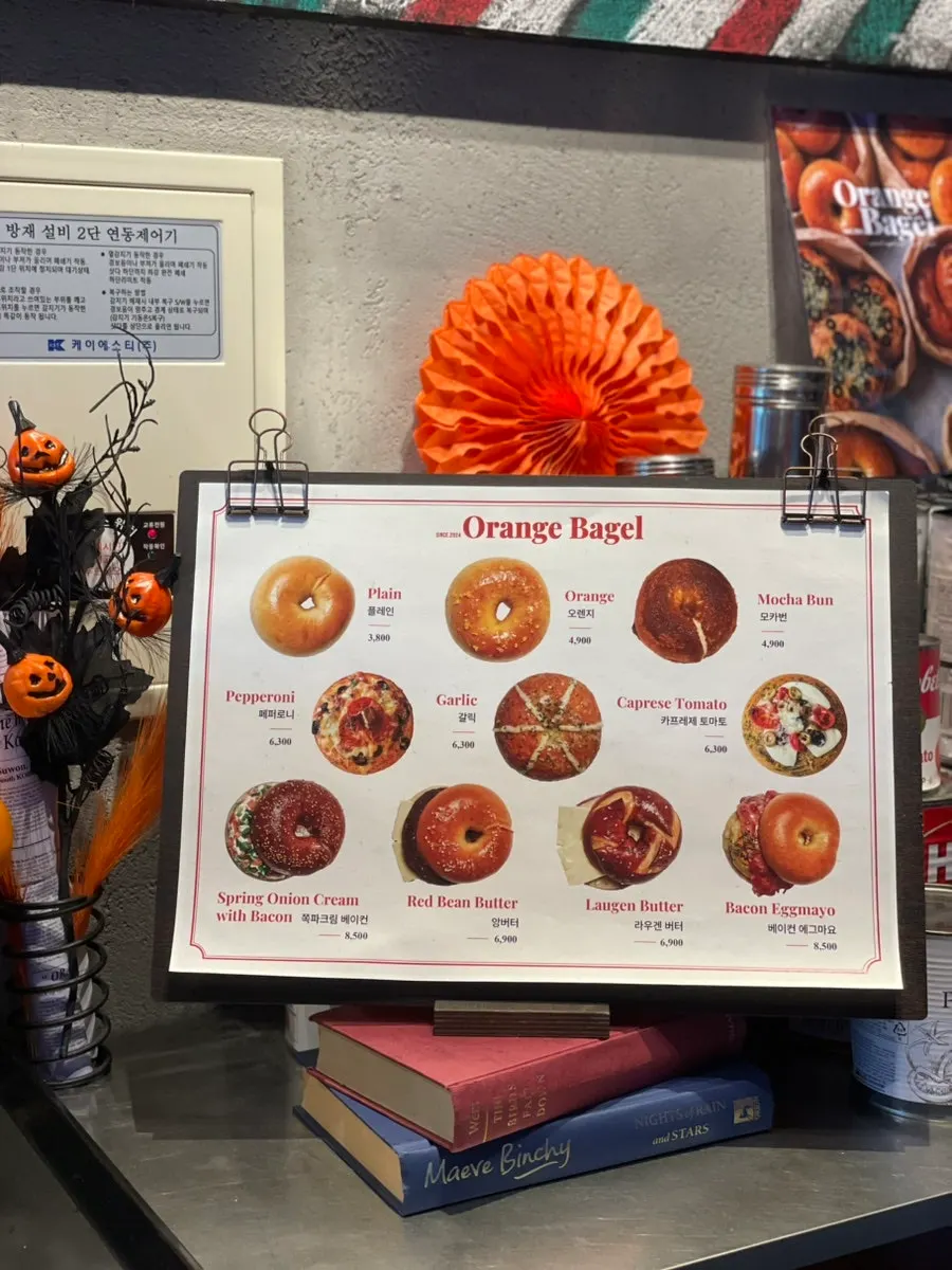 Sign for Orange Bagel's signature top10 bagels