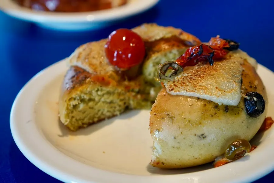 Caprese tomato bagel topped with cheese and tomato