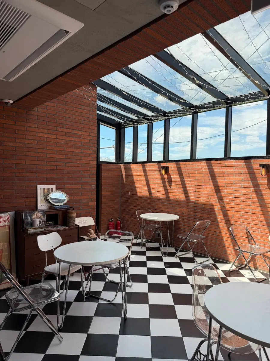 Indoor terrace seating on the 2nd floor with floor-to-ceiling windows