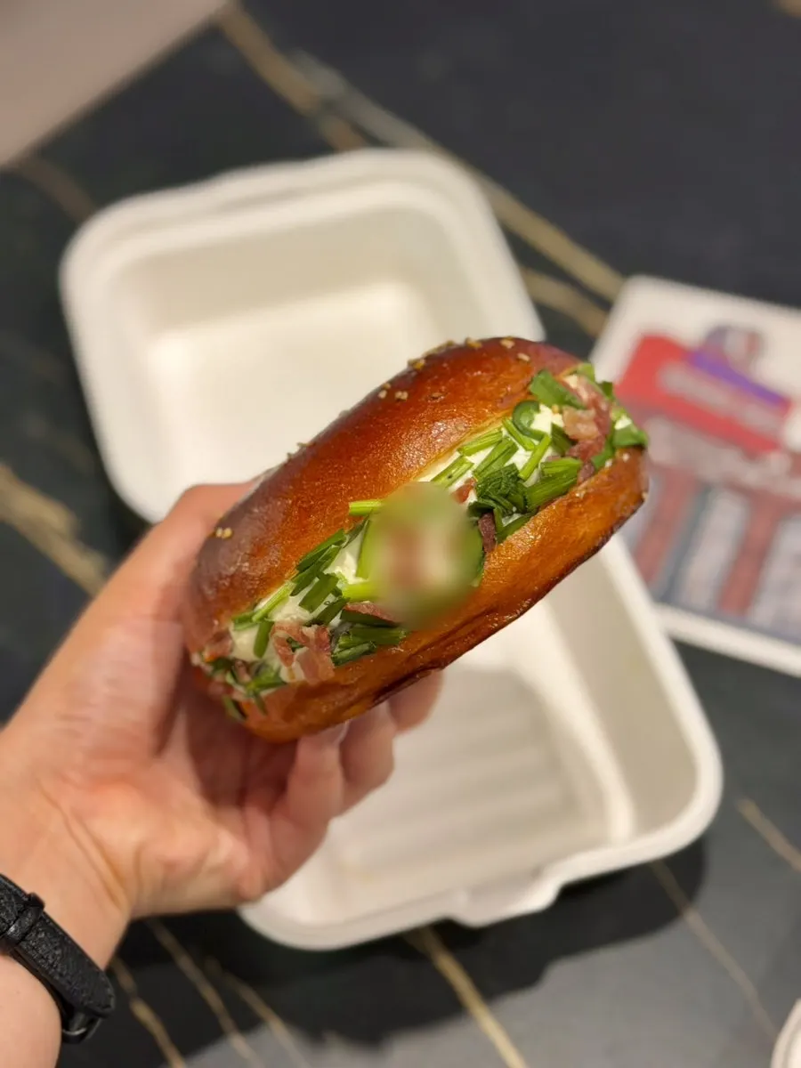 Scallion cream cheese bagel piled high with scallions