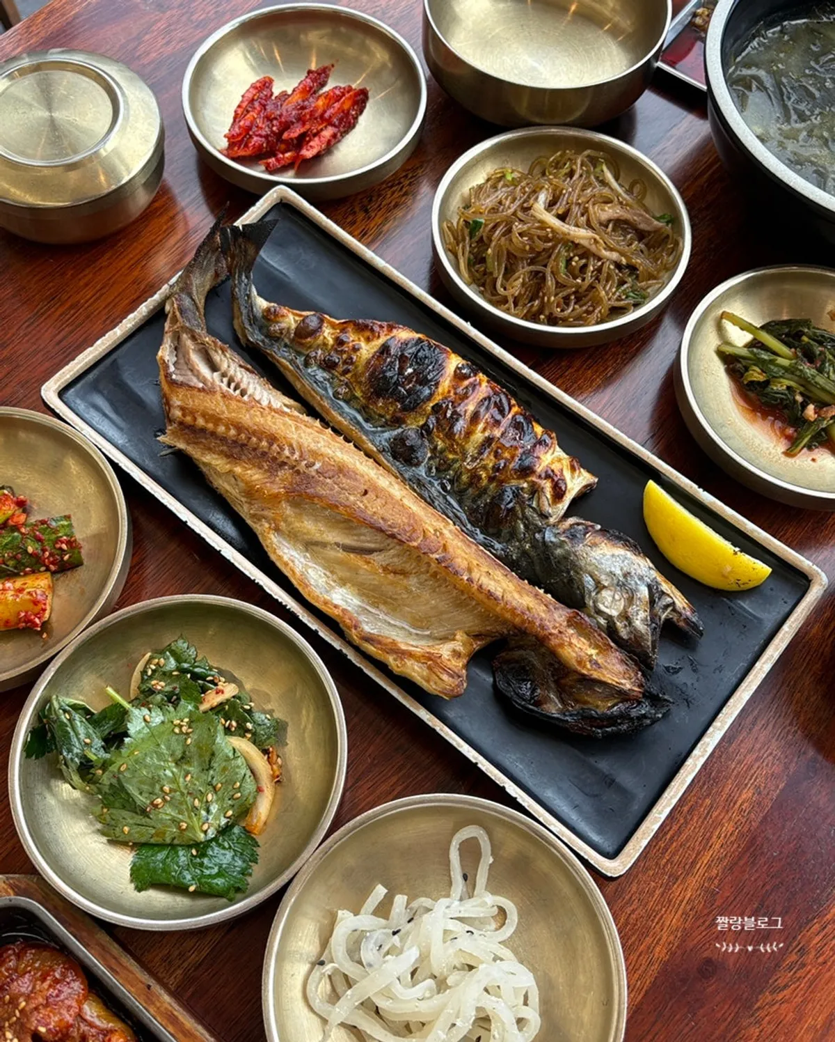 Vertical photo of grilled mackerel straight from the wood-fired oven
