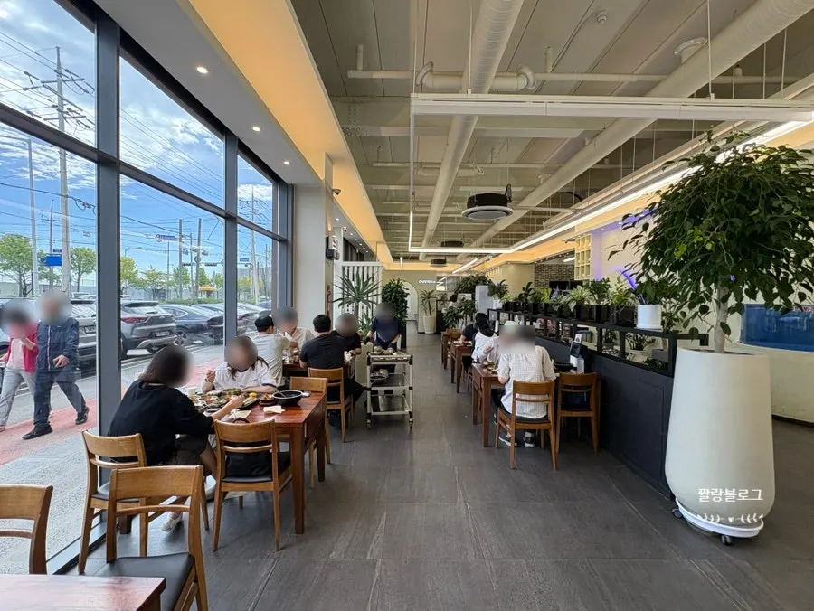 Seating area with floor-to-ceiling windows and bright lighting