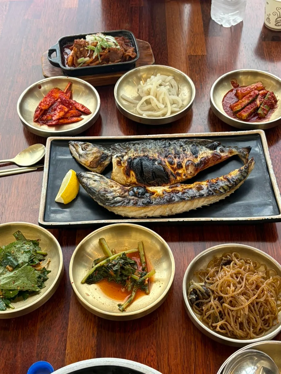 Full table spread of grilled mackerel for two