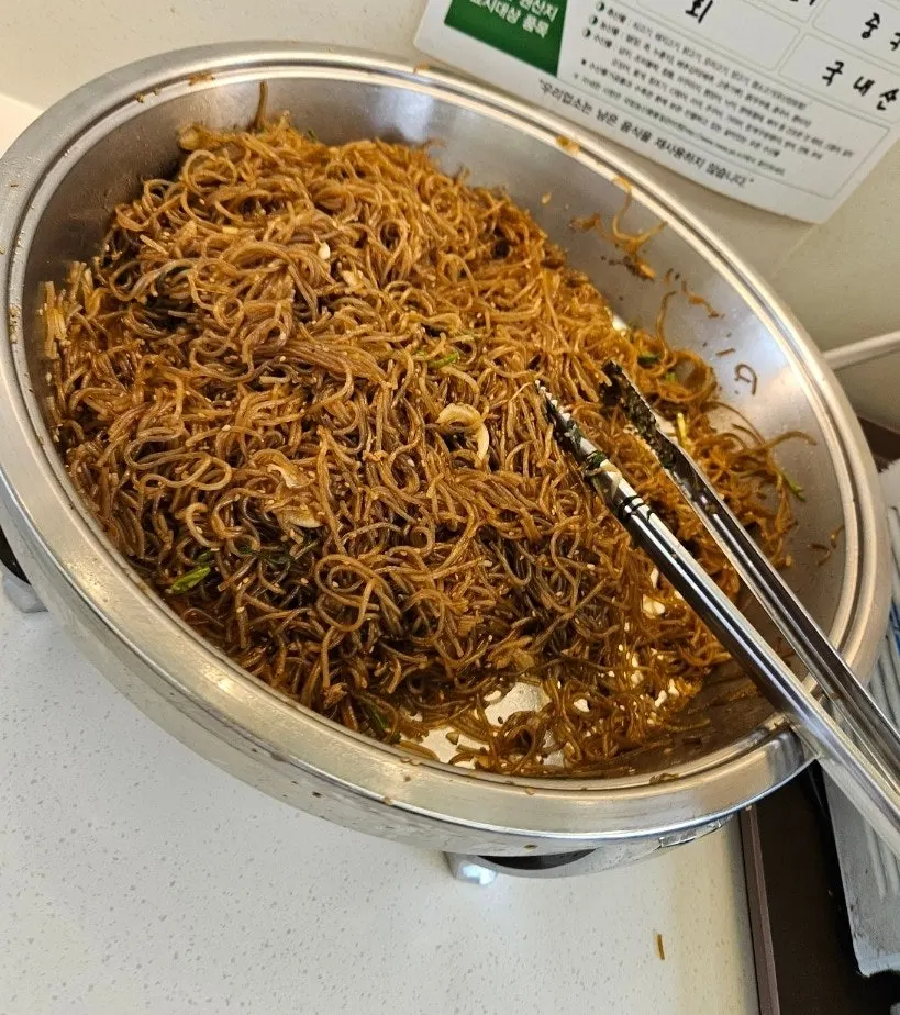 Side dishes and tongs at the self-serve bar