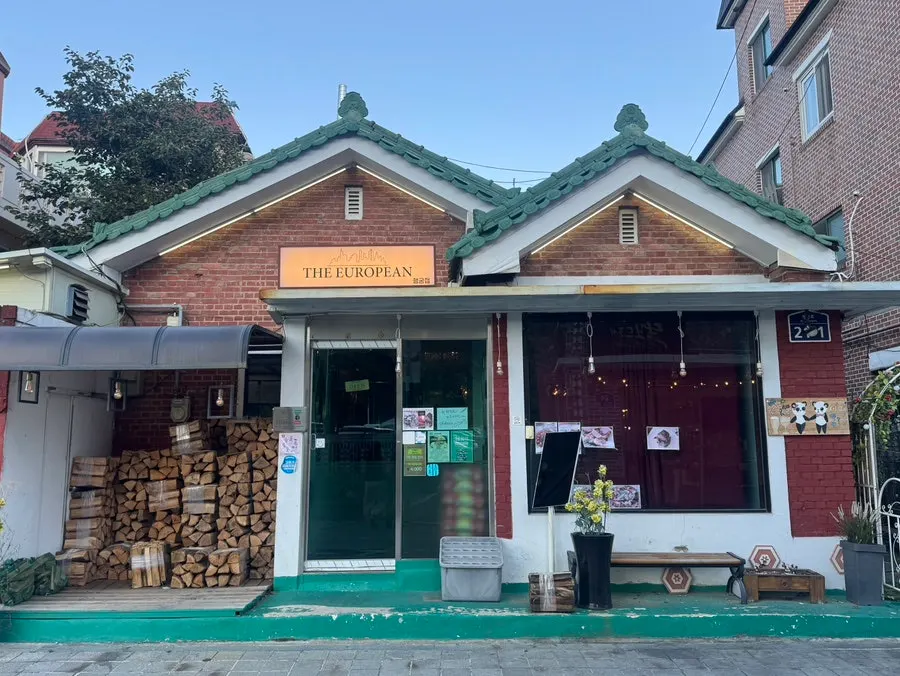Restaurant exterior with red brick and mint-colored roof tiles