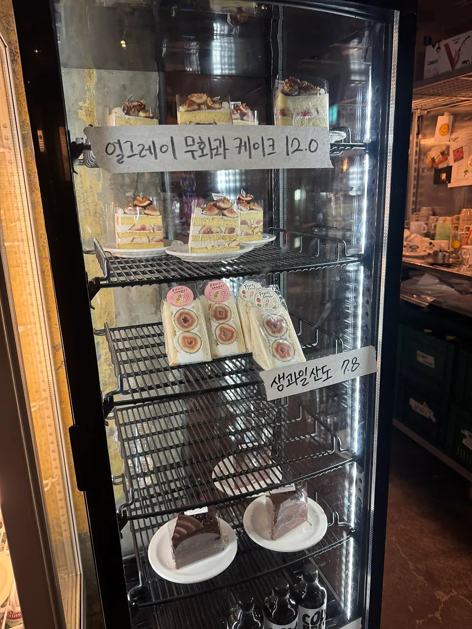 Dessert display case with cakes